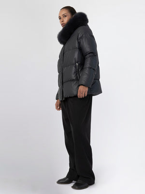 Stylish black puffer jacket with a luxurious fur collar, paired with wide-leg trousers, showcasing MEOTINE's modern winter fashion.