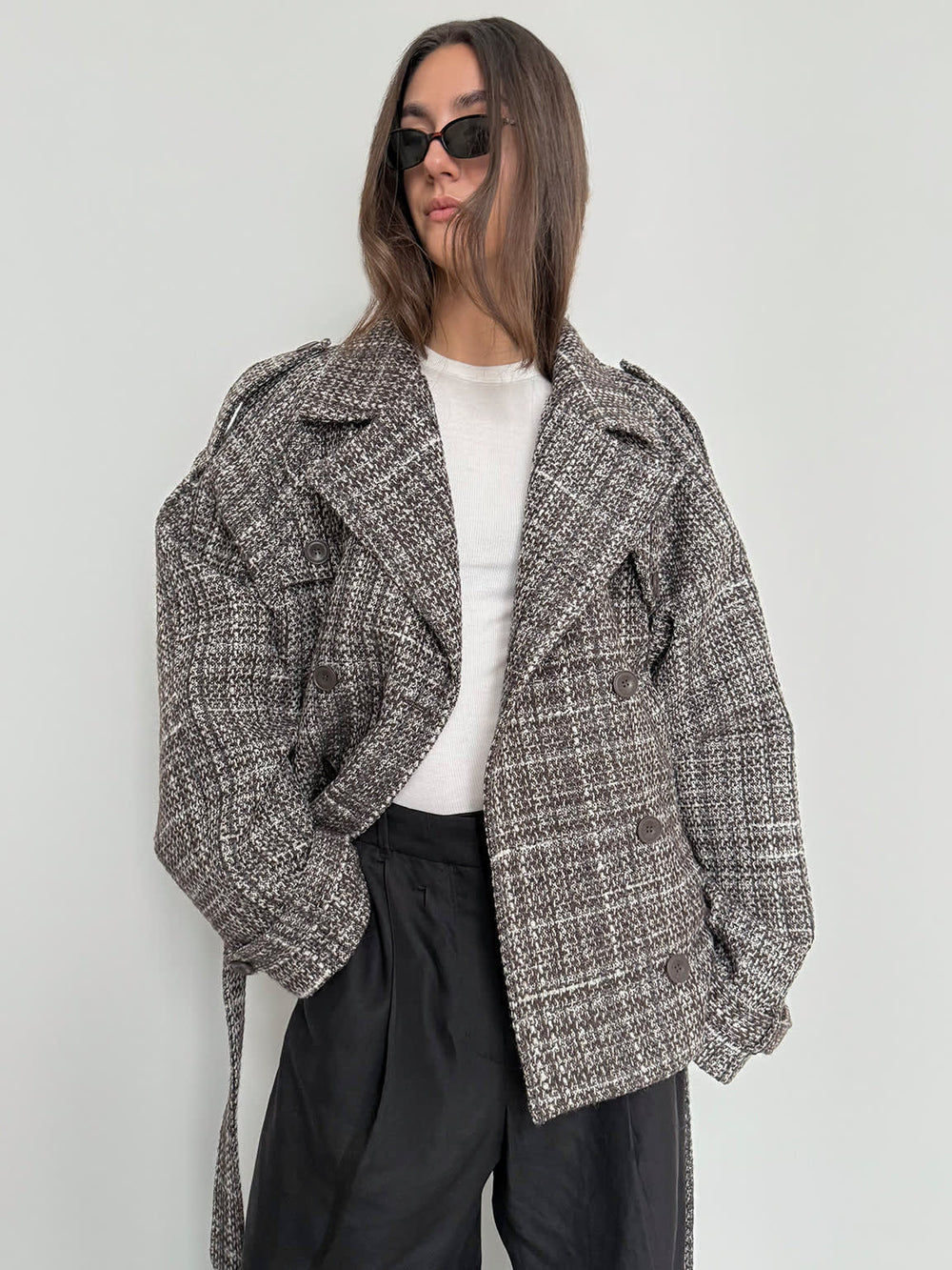 Stylish oversized brown plaid coat with a belted waist, worn by a model in sunglasses, showcasing MEOTINE's chic design.