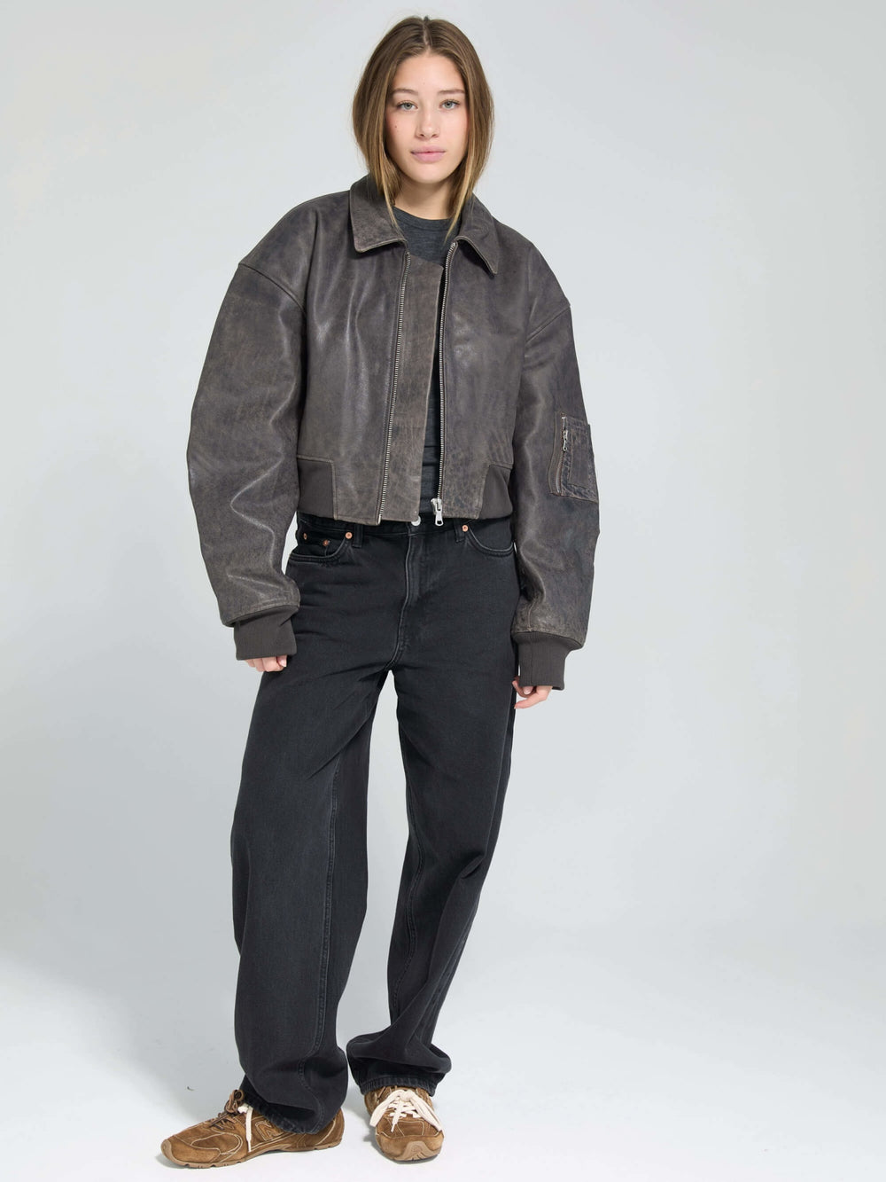 Stylish cropped leather jacket in dark brown, featuring a zip closure and relaxed fit, perfect for a trendy look by MEOTINE.