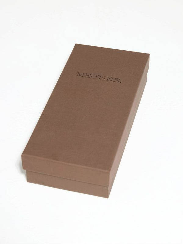Brown rectangular box with a minimalist design, featuring the brand name "MEOTINE" elegantly embossed on the top.